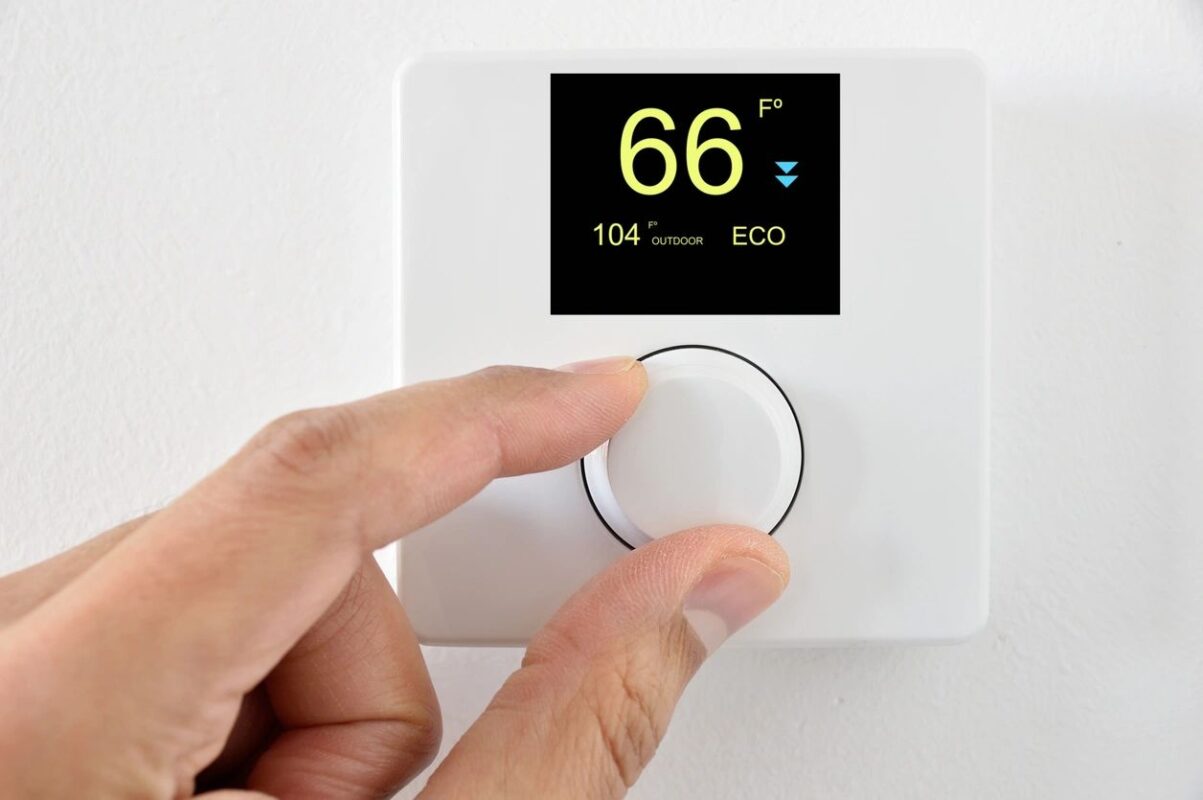 Adjusting digital thermostat temperature for HVAC system in Boston MA